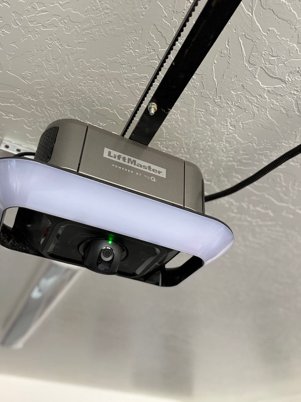 LiftMaster garage door opener with integrated camera and LED light mounted on ceiling.