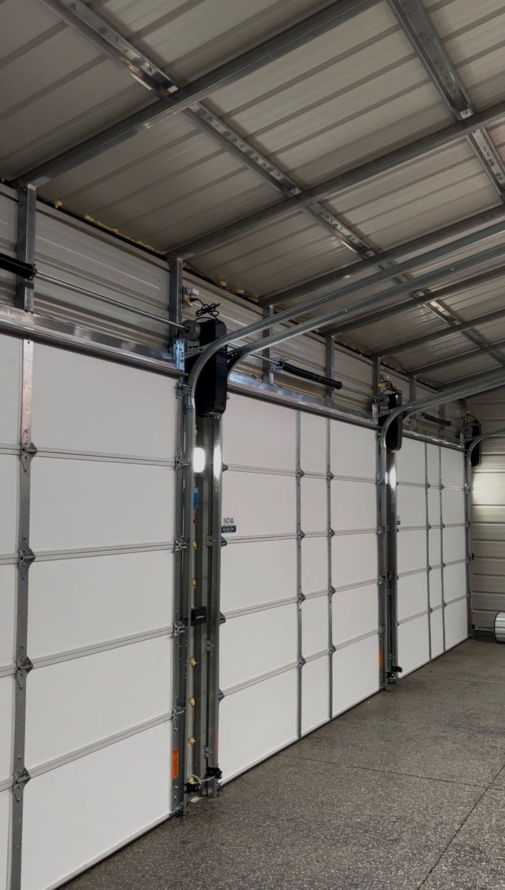 Modern garage interior featuring sleek white doors and metal tracks for smooth operation.