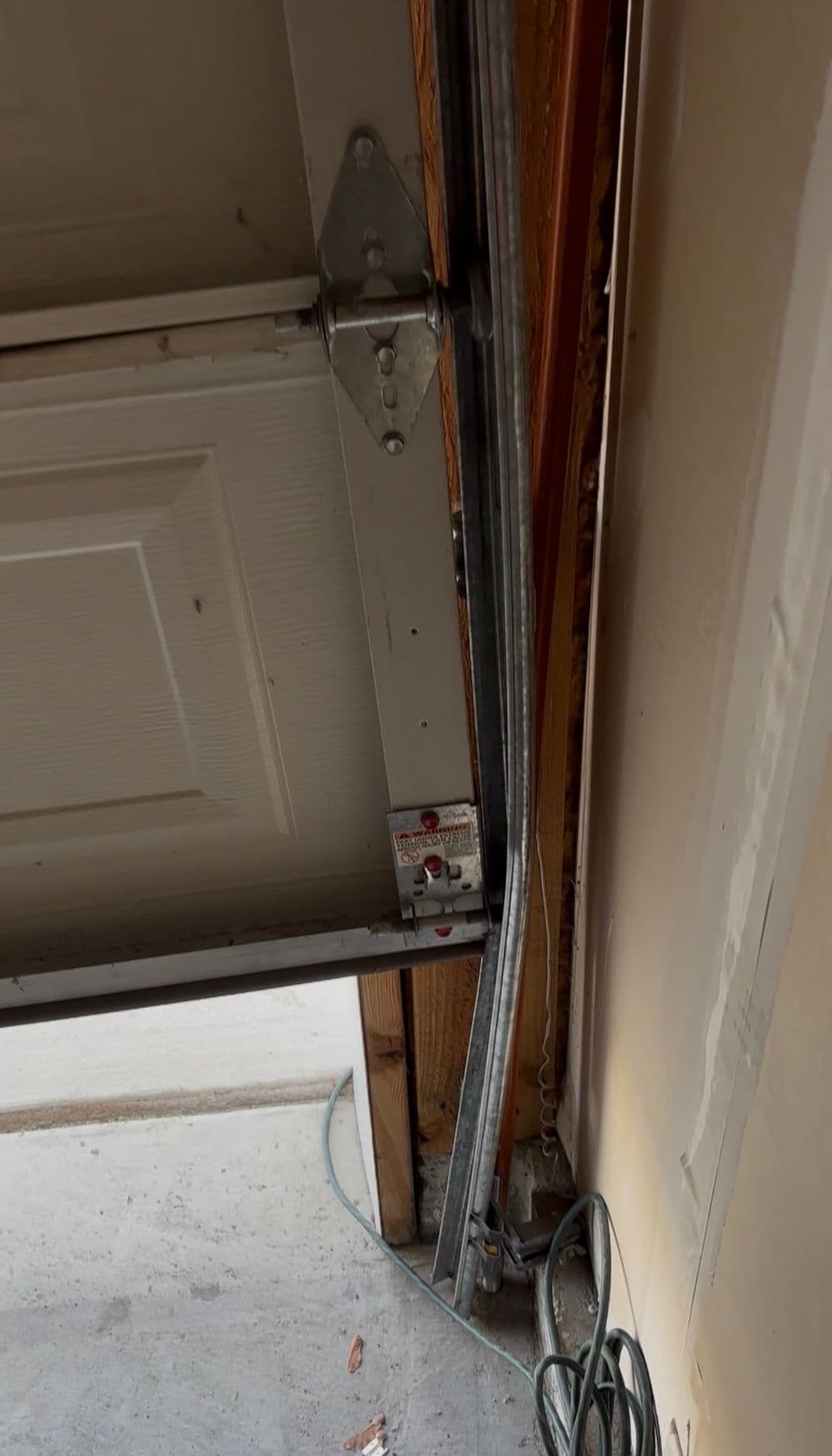 Detailed view of a garage door mechanism with visible track and electrical wiring.