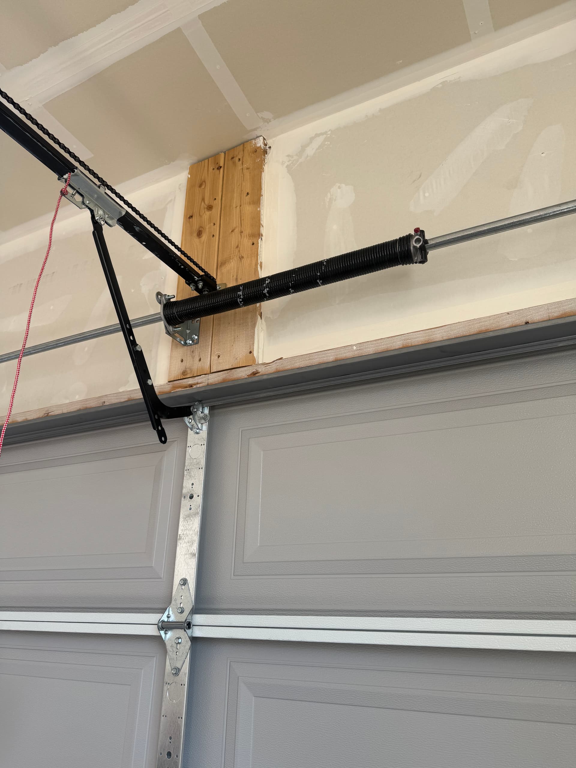 Worn Garage Door Spring Repaired and Running Smooth Again image