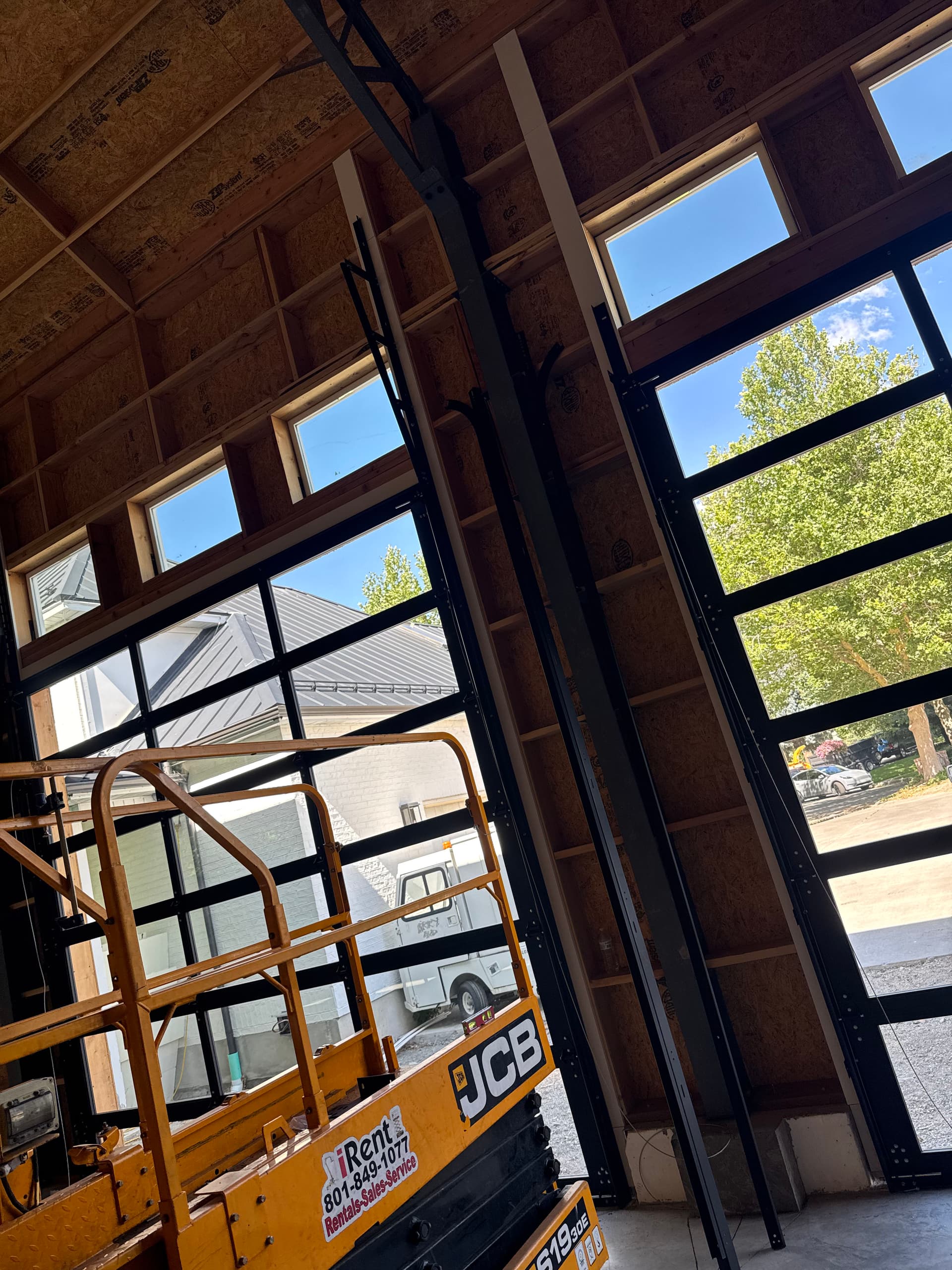 Full-View Garage Door Install with Black Aluminum Framing and Double-Pane Glass image