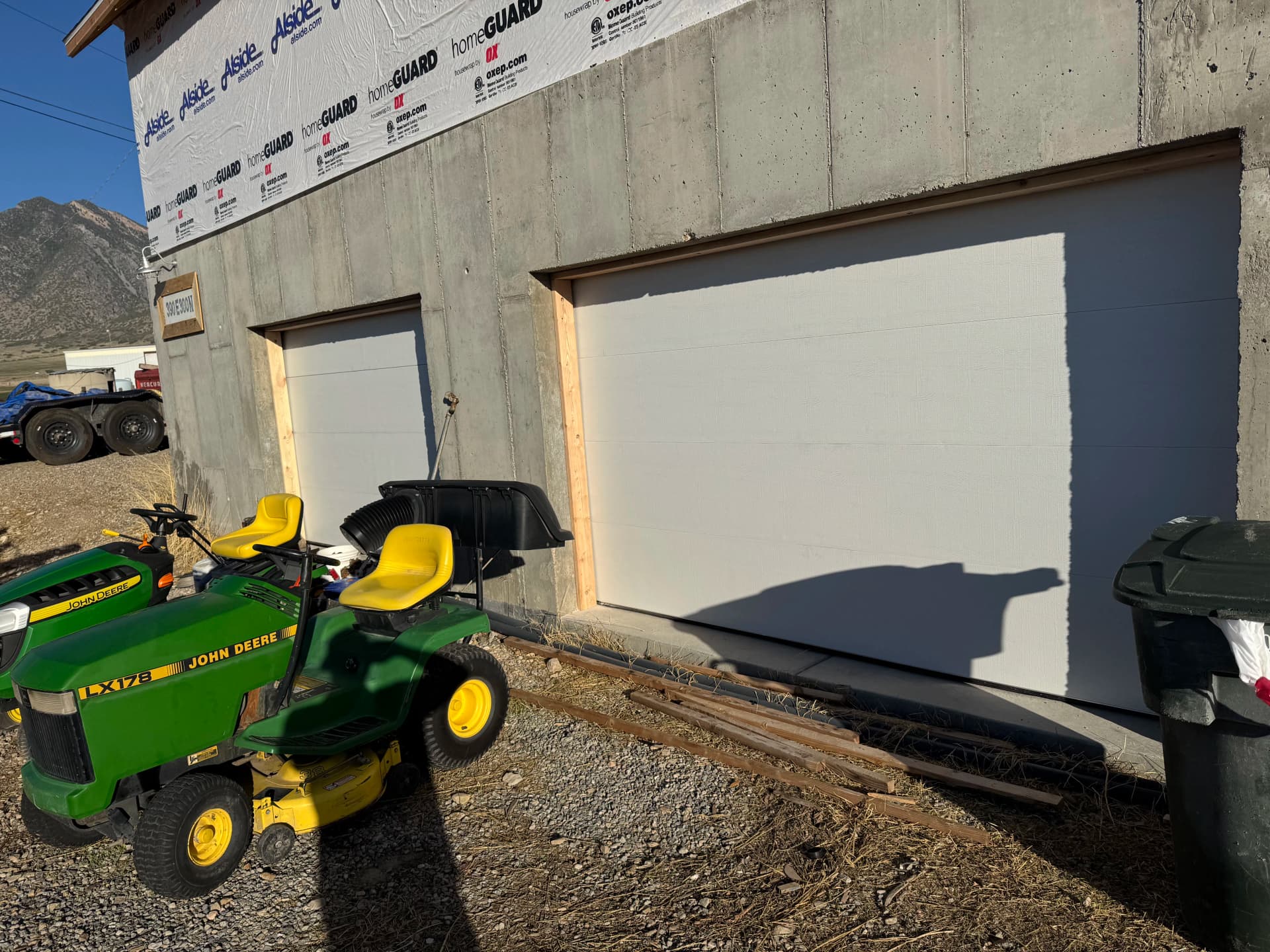 Two Flush White Garage Doors Installed on a Storage Building image